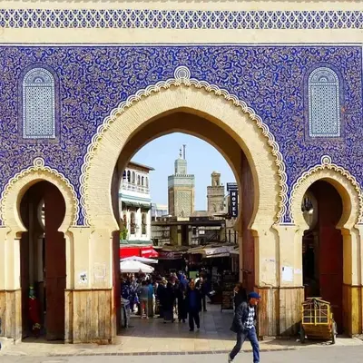 an archway in a city with people walking through it at Appartement Atlas City Center in Fès