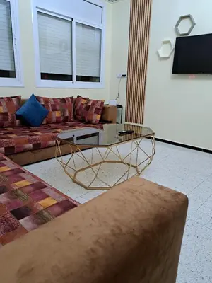 a living room with a couch and a coffee table at Appartement Atlas City Center in Fès