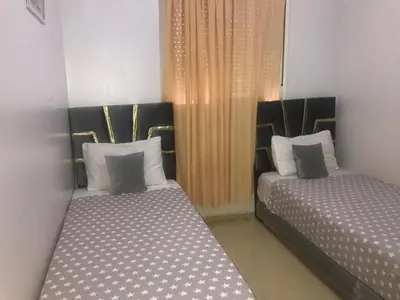 two beds sitting next to each other in a room at Maison Samy in Ifrane
