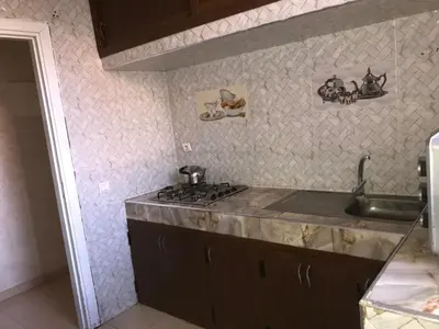 a kitchen with a sink and a counter top at Maison Samy in Ifrane