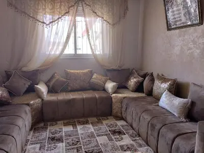 a living room with a couch and a window at Maison Samy in Ifrane