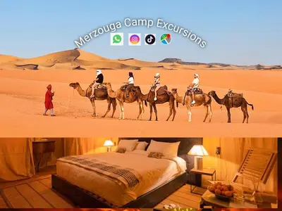 a group of people riding on camels in the desert at Merzouga Camp Excursions in Merzouga
