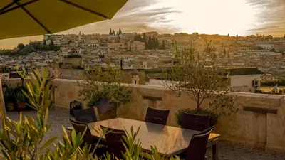 a table and chairs with a view of a city at Karawan Riad in Fès