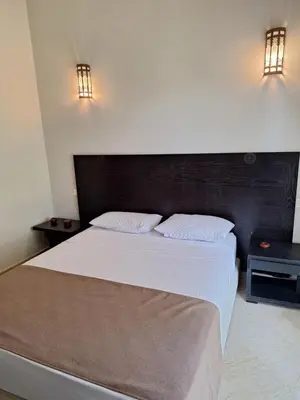 a bedroom with a large bed and two night stands at Villa des oliviers in Marrakech