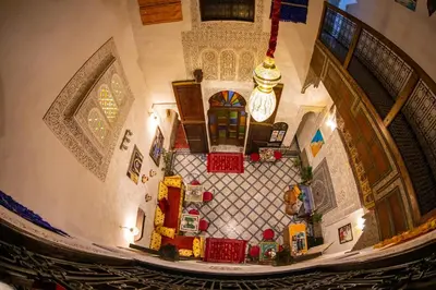 an overhead view of a staircase with red baskets at Riad LalaMoune in Fès