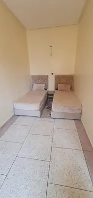 two beds sitting in a room with a room with two at hôtel mamounia el hajeb in El Hajeb