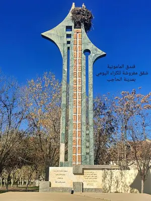 a tall monument with a bird on top of it at hôtel mamounia el hajeb in El Hajeb
