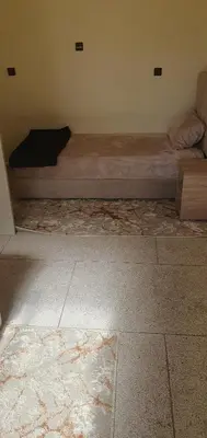 a bed sitting in a corner of a room at hôtel mamounia el hajeb in El Hajeb