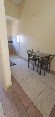 a dining room with a table and a table and chairs at hôtel mamounia el hajeb in El Hajeb
