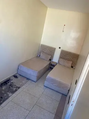 a small room with two beds in it at hôtel mamounia el hajeb in El Hajeb