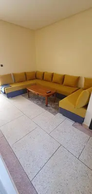 a living room with a couch and a coffee table at hôtel mamounia el hajeb in El Hajeb