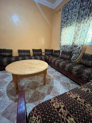 a living room with a couch and a table at Belo appart bassatine in Meknès