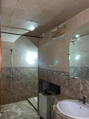 a bathroom with a sink and a shower and a mirror at Belo appart bassatine in Meknès