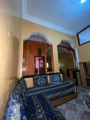 a bedroom with a bed with blue and white pillows at Belo appart bassatine in Meknès