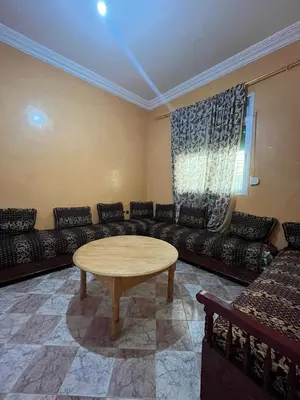 a living room with a couch and a table at Belo appart bassatine in Meknès