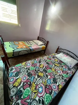 two beds sitting next to each other in a room at Belo appart bassatine in Meknès