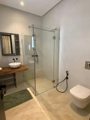 a bathroom with a shower and a toilet and a sink at Palmeria luxery in Marrakech