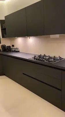a kitchen with a stove top and black cabinets at Palmeria luxery in Marrakech