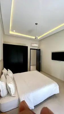 a bedroom with a large bed with white sheets and pillows at Palmeria luxery in Marrakech