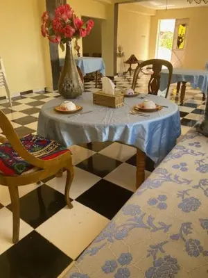 a room with a table with a vase of flowers on it at Gite Cèdre Gouraud in Azrou