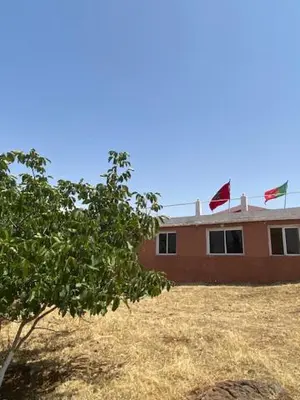 two flags are flying on top of a building at Gite Cèdre Gouraud in Azrou