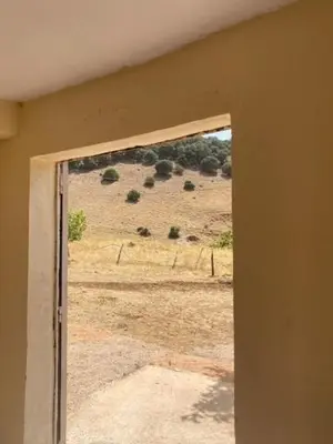 a window in a room with a view of a field at Gite Cèdre Gouraud in Azrou