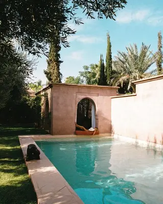 a swimming pool in front of a house at LA PORTE AU LION - Marrakech in Marrakech