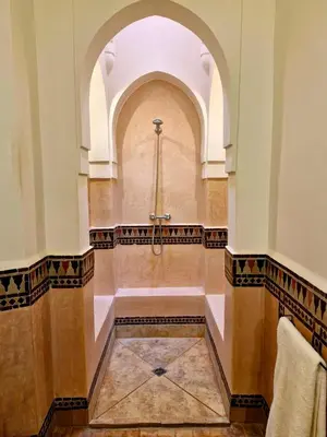 a church aisle with a cross on the wall at LA PORTE AU LION - Marrakech in Marrakech