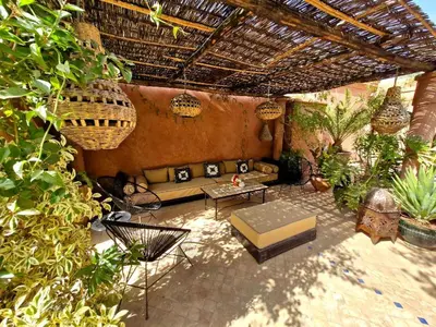 an outdoor patio with a couch and a table at LA PORTE AU LION - Marrakech in Marrakech