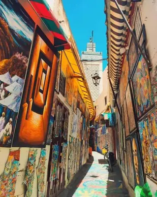 an alley with paintings on the side of a building at Appartement Centre Ville - ATLAS in Fès