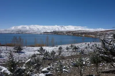 a view of a lake with snow on the ground at Kasbah ADRAR in Imilchil