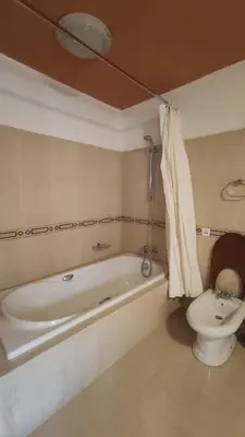 a bathroom with a bath tub and a toilet at Kasbah ADRAR in Imilchil