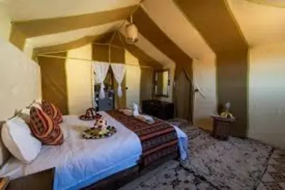 a bedroom with a large bed in an attic at Sahara Elegance Camp in Merzouga