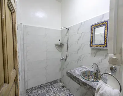 a bathroom with a sink and a mirror at Dar Lala Mama in Fès