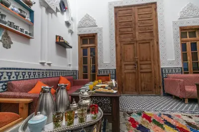 a living room with a couch and a table at Dar Lala Mama in Fès