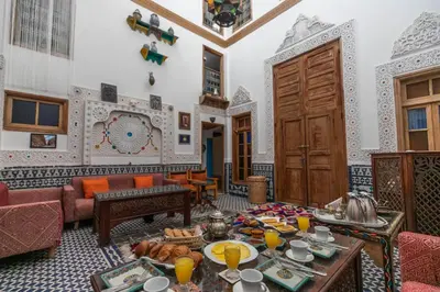 a living room with a table with food on it at Dar Lala Mama in Fès