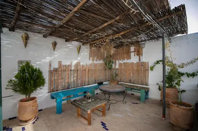 a room with a blue bench and a table at Dar Lala Mama in Fès