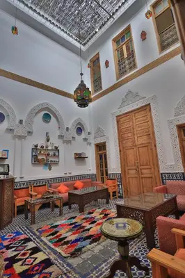 a living room with a couch and a table at Dar Lala Mama in Fès