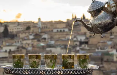 a tray of four glasses of beer with a pitcher at Riad Ridaya in Fès