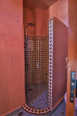 a shower in a bathroom with a glass door at Riad Ridaya in Fès