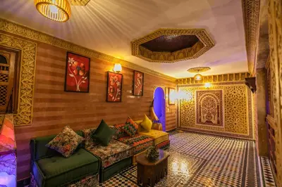 a living room with a couch and a table at Riad Ridaya in Fès