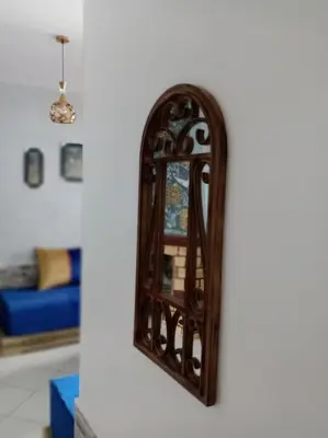 a mirror on a wall in a living room at Luxury Ifrane House in Ifrane