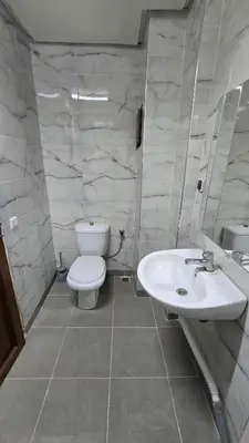 a bathroom with a white toilet and a sink at Luxury Ifrane House in Ifrane