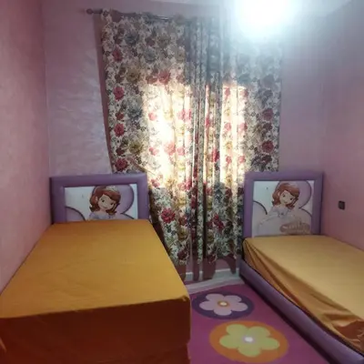 two beds in a room with a doll bedroom at Chez Sondos in Marrakech