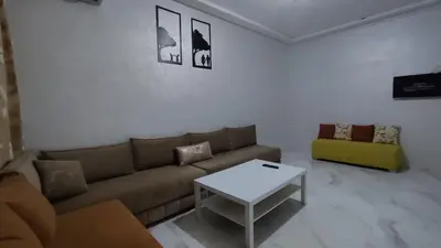 a living room with a couch and a table at Coin vert in Fès