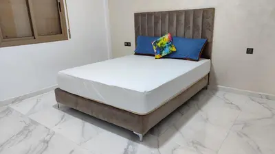 a bed with two pillows on it in a room at Coin vert in Fès