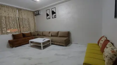 a living room with a couch and a table at Coin vert in Fès