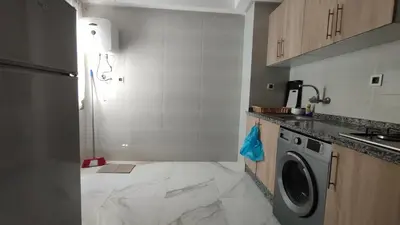 a small kitchen with a washing machine in it at Coin vert in Fès