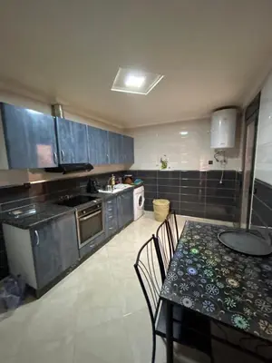 a kitchen with a table and a table and chairs at 800 Miles of Travel in Ouarzazate