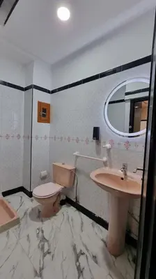 a bathroom with a toilet and a sink at Spacieux Appartement in Azrou